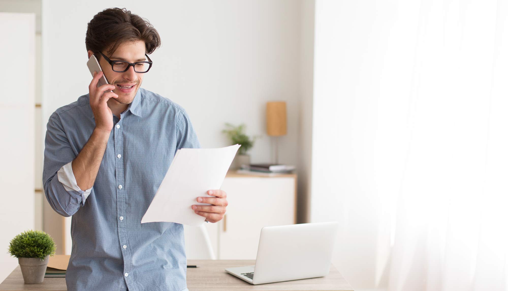 A young man calls the bank about debt consolidation with Halifax