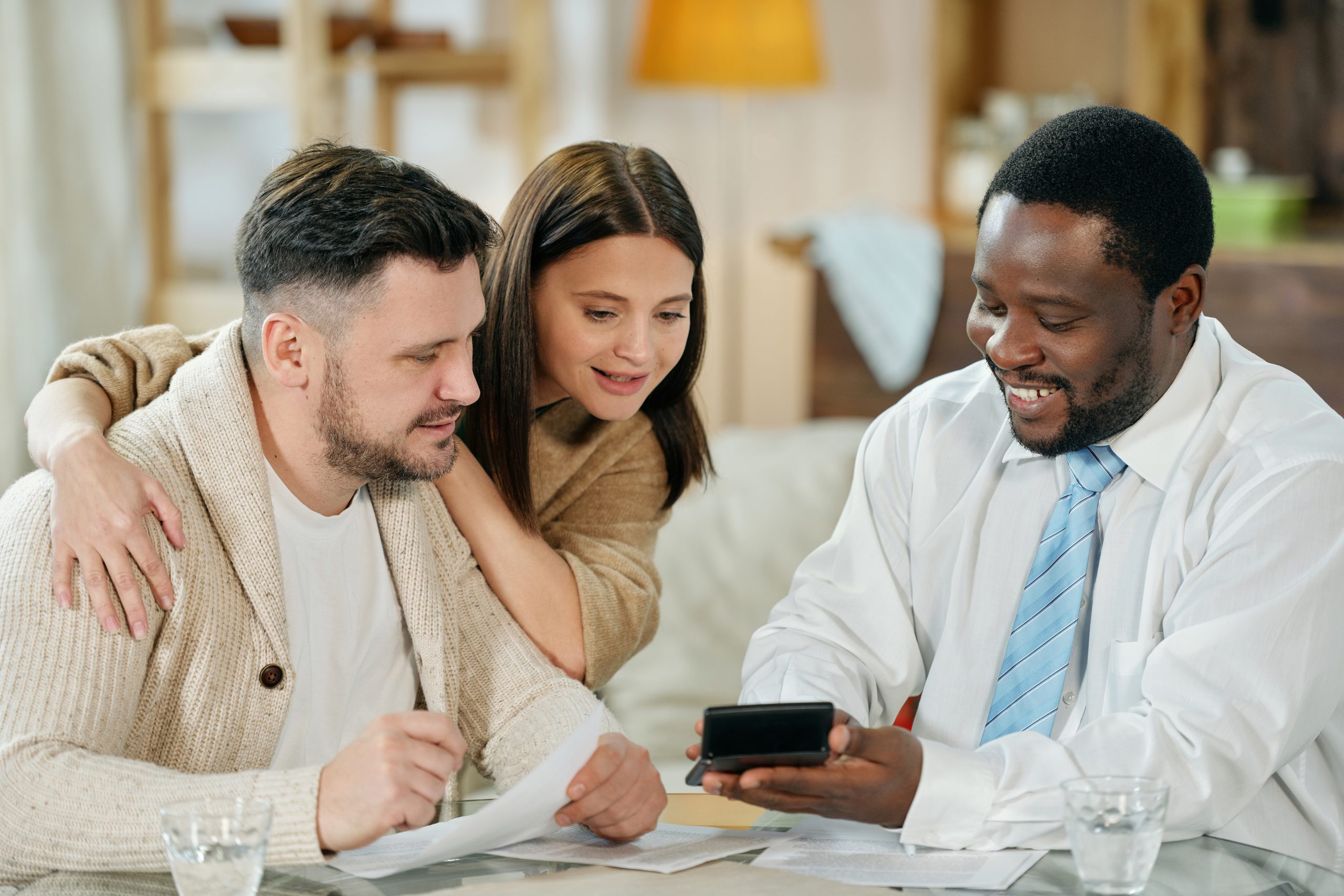 A bank worker explains to a young couple about Barclays bank debt consolidation loans