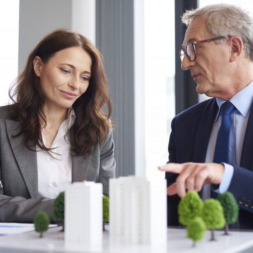 A male coworker gives advice to a female colleague about Royal Bank of Scotland debt consolidation loans