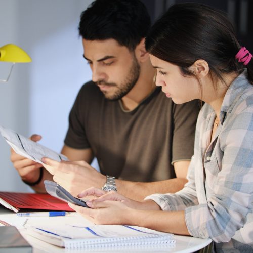Man and woman worried about debts and thinking about a debt management plan
