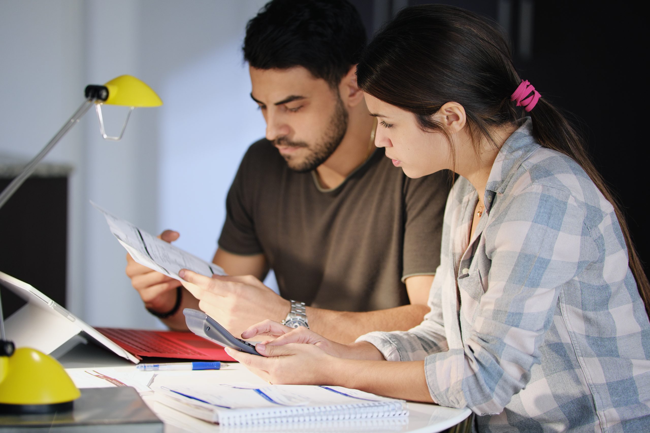 Man and woman worried about debts and thinking about a debt management plan